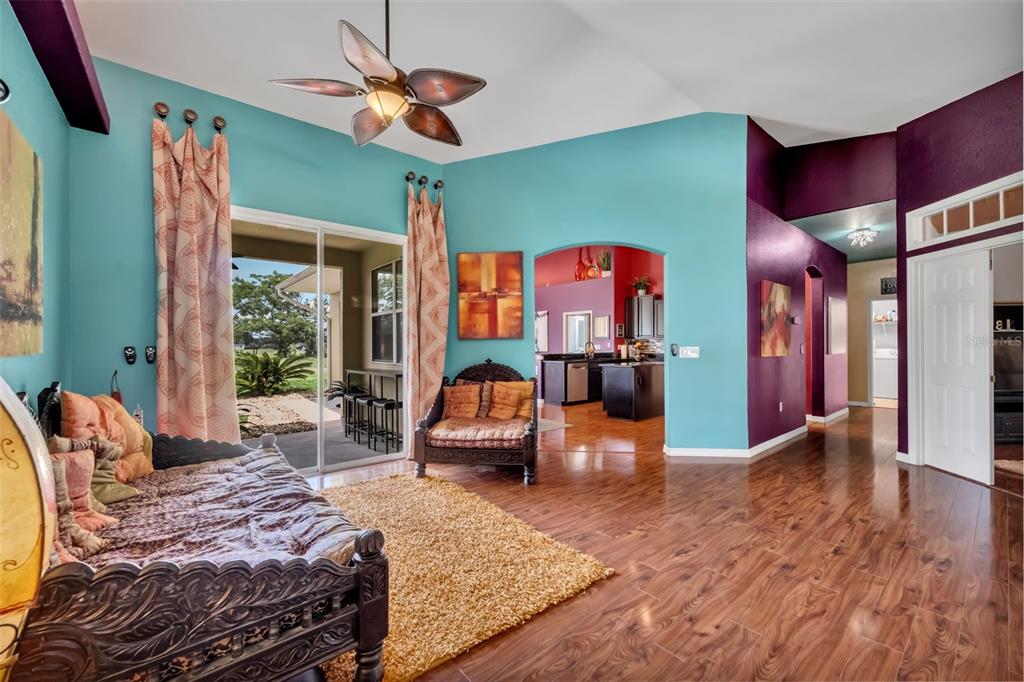 4946 Northeast 124th Road Oxford, FL 34484 - Photo 7 of 69 a bedroom with a bed and a chandelier