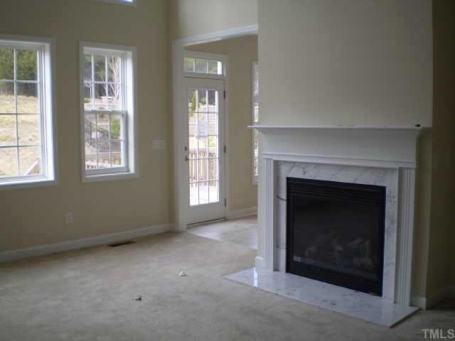 3216 Queensland Road Raleigh, NC 27614 - Photo 3 of 12 2-story livingrm with lots of windows & cosy fireplace
