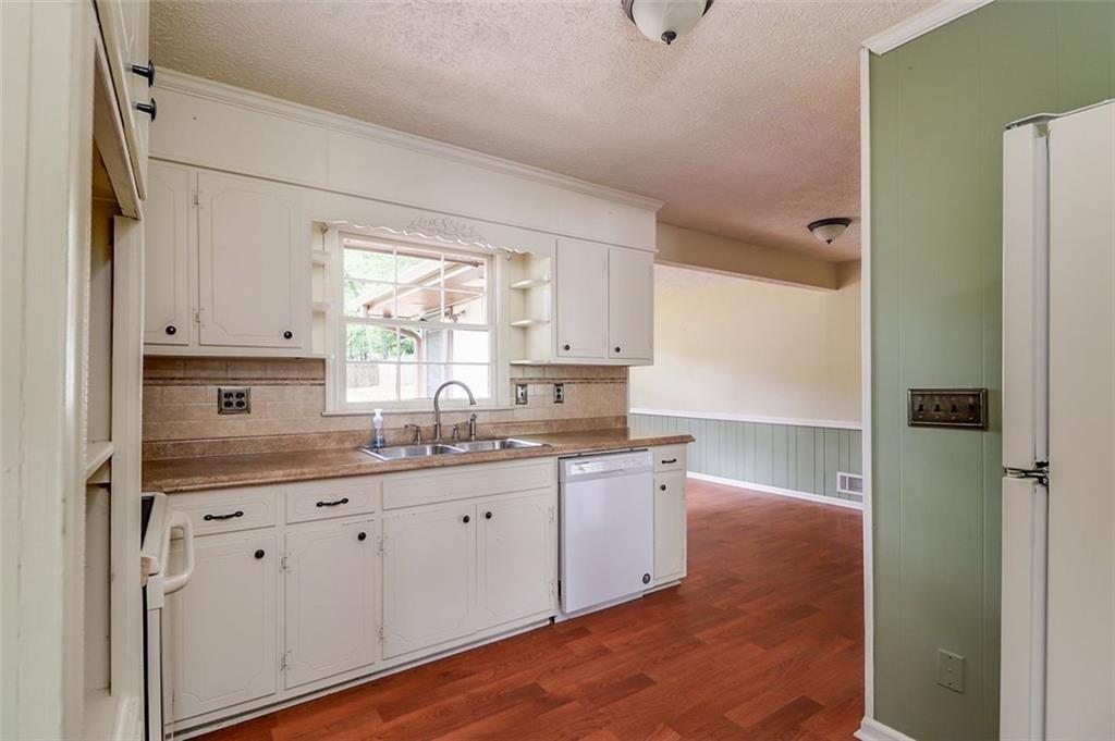 1291 Stephens Street Southwest Lilburn, GA 30047 - Photo 14 of 22 a kitchen with appliances cabinets a sink and a window