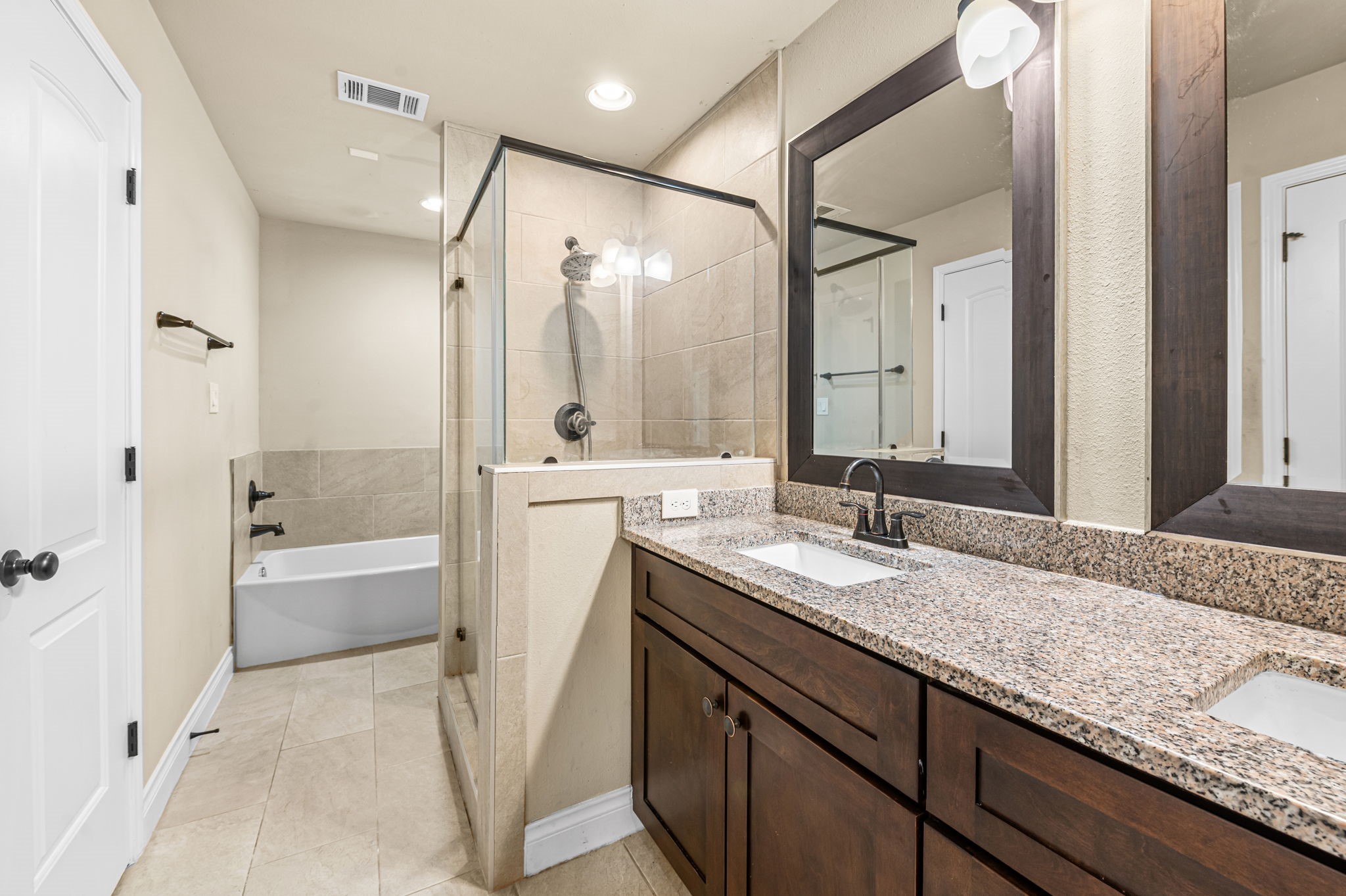 6838 Foster Street Houston, TX 77021 - Photo 15 of 24 Primary bathroom with an extended granite vanity, dual sinks, and ample cabinet storage
