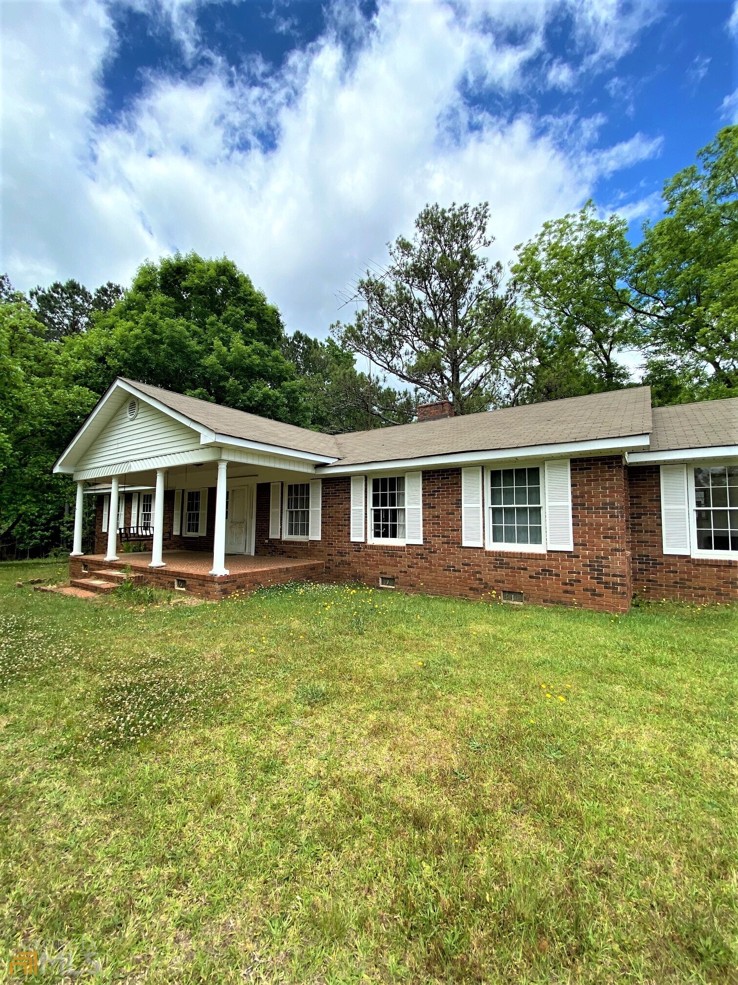 1491 Jack Malcom Road Madison, GA 30650 - Photo 1 of 1 a front of a house with a garden