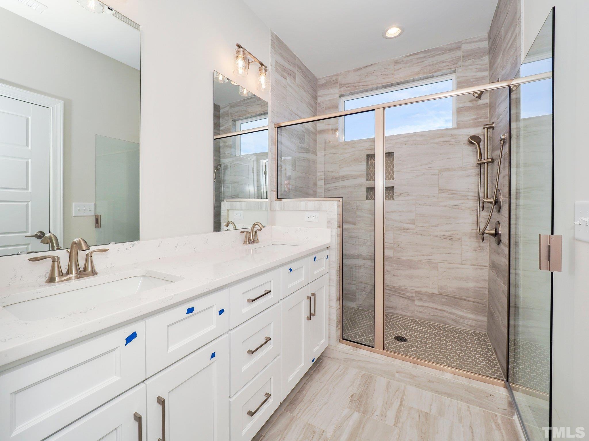 4924 Trek Lane Raleigh, NC 27606 - Photo 22 of 24 a bathroom with a double vanity sink mirror and shower