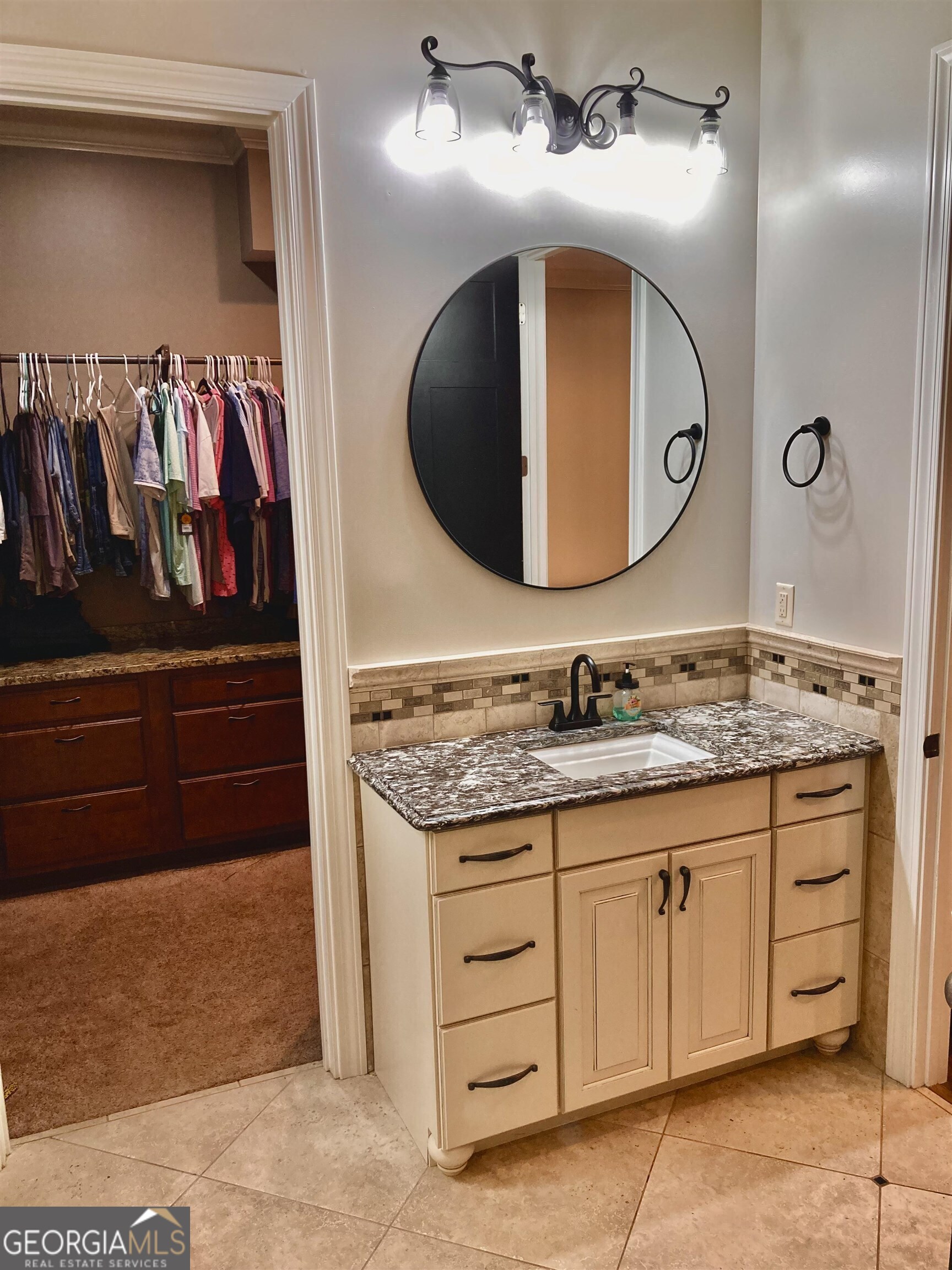 243 Ralls Road Hogansville, GA 30230 - Photo 18 of 39 a bathroom with a granite countertop sink and a mirror