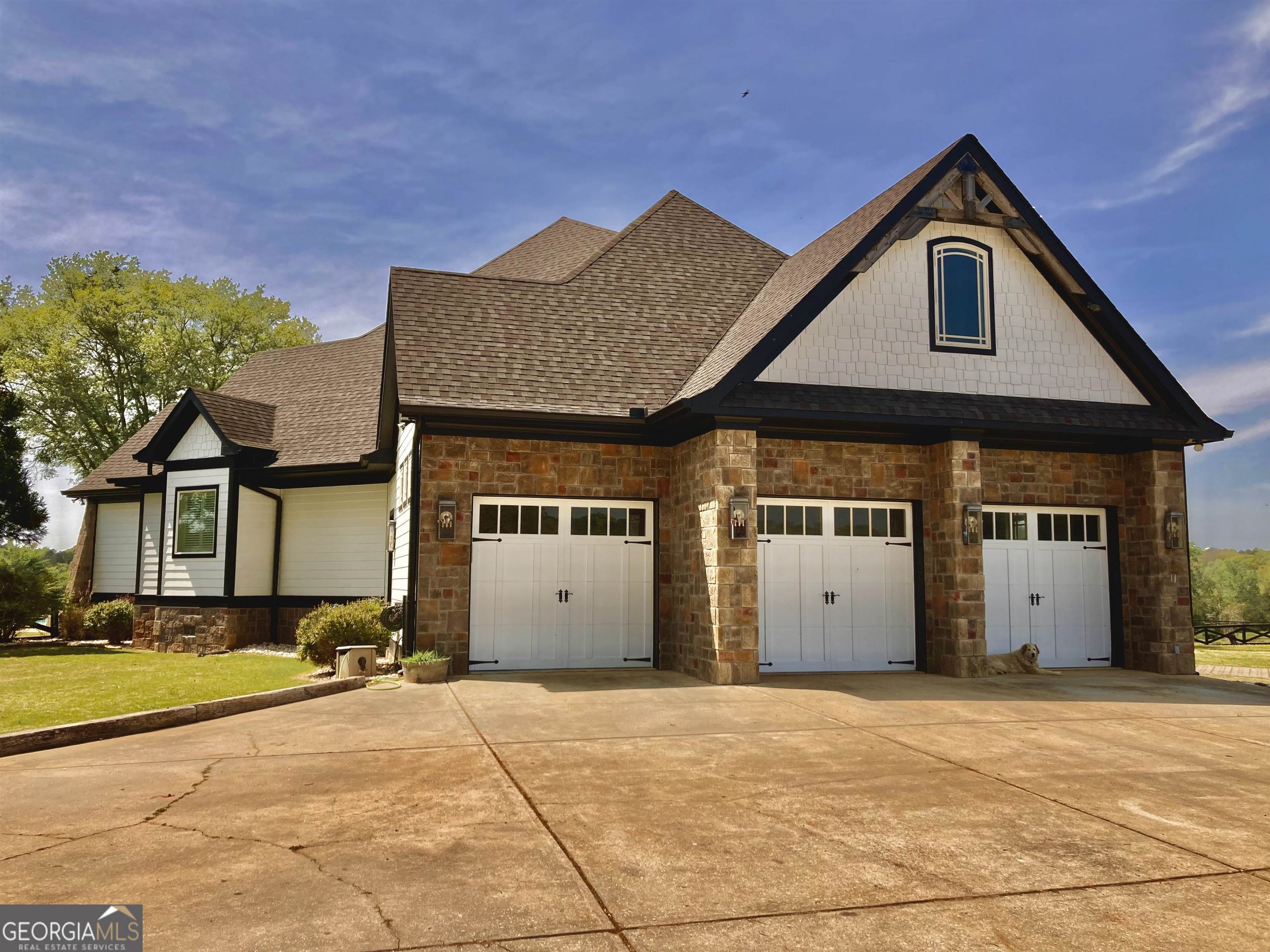 243 Ralls Road Hogansville, GA 30230 - Photo 2 of 39 a front view of a house with a yard and garage