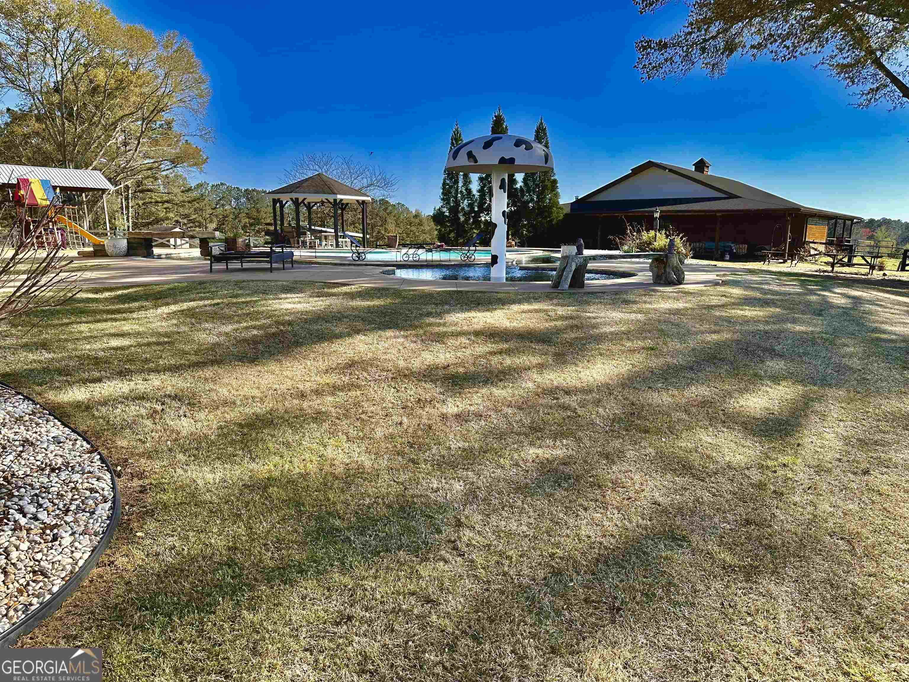 243 Ralls Road Hogansville, GA 30230 - Photo 25 of 39 a backyard of a house with table and chairs