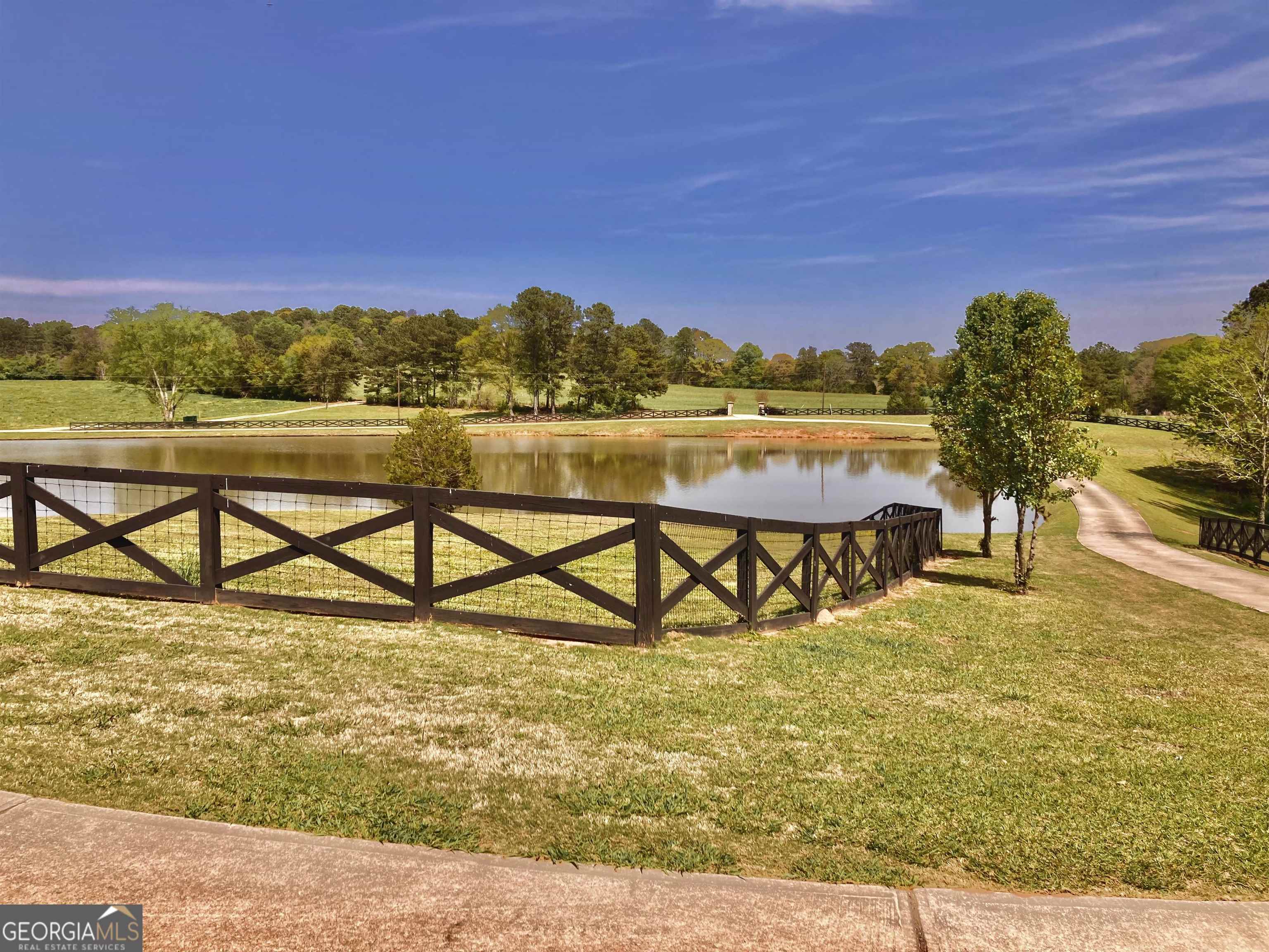 243 Ralls Road Hogansville, GA 30230 - Photo 3 of 39 a view of a lake with a building in the background