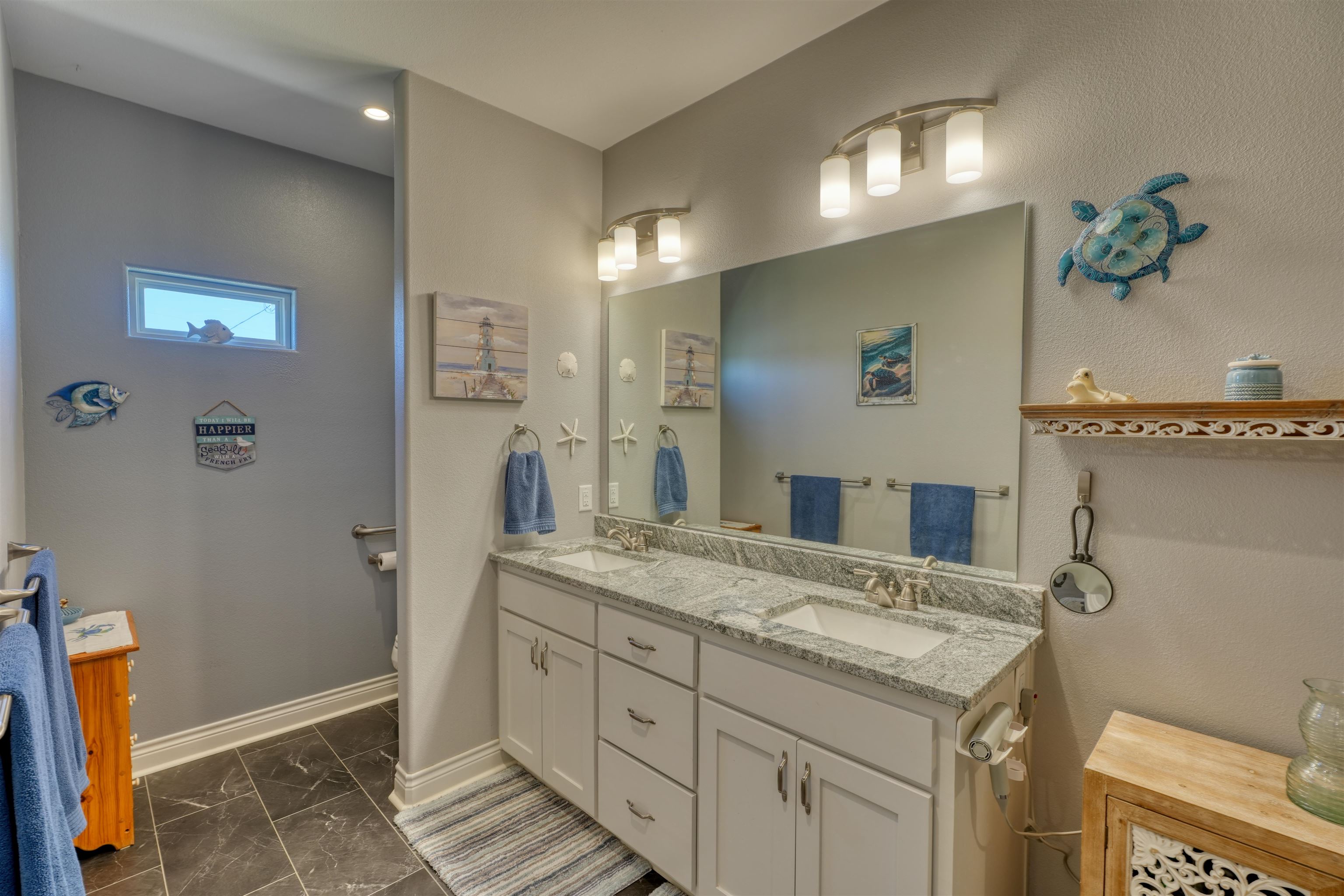202 Rio Llano Drive West Llano, TX 78643 - Photo 12 of 29 a bathroom with a granite countertop sink a toilet and a mirror
