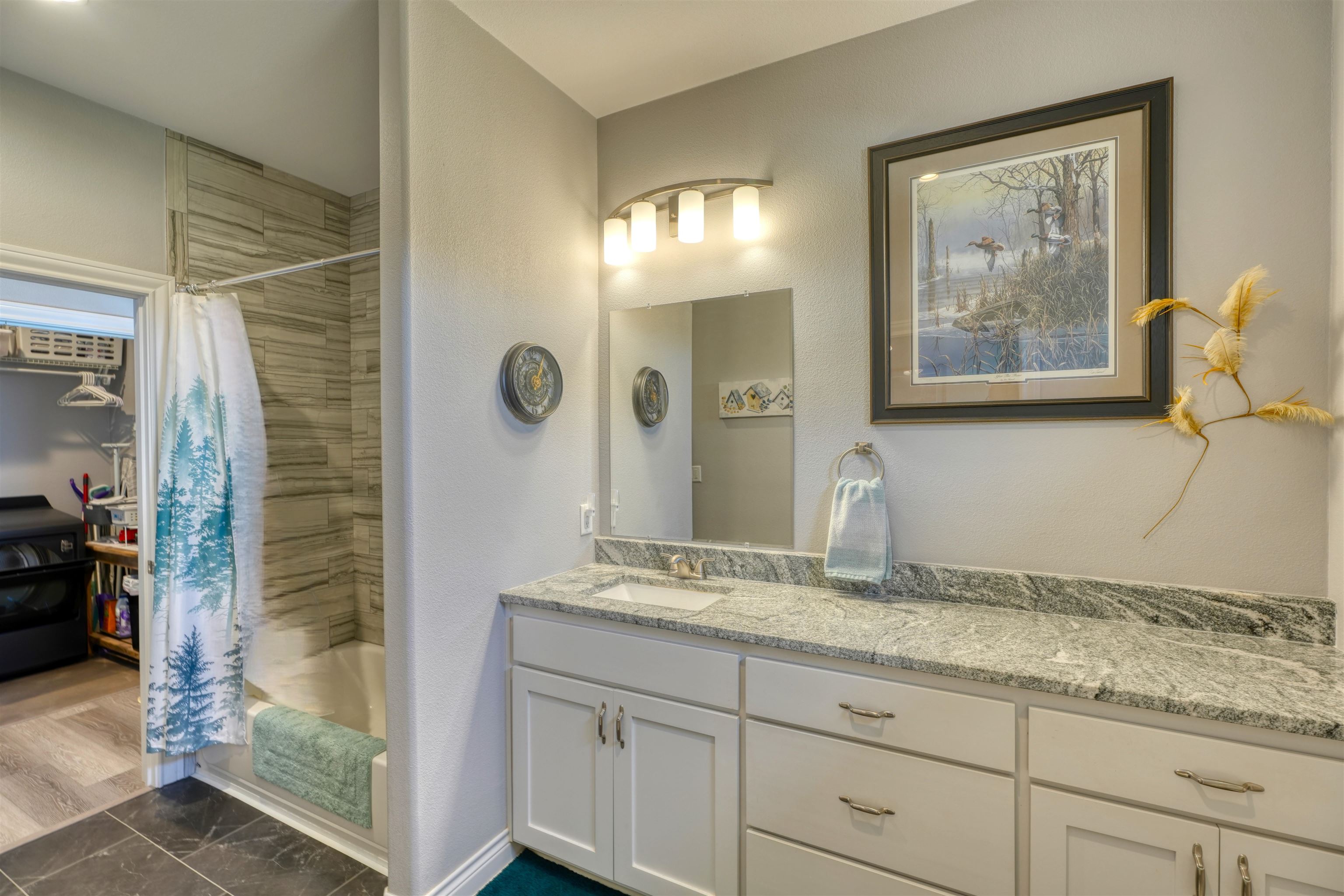 202 Rio Llano Drive West Llano, TX 78643 - Photo 15 of 29 a bathroom with a granite countertop sink and a mirror