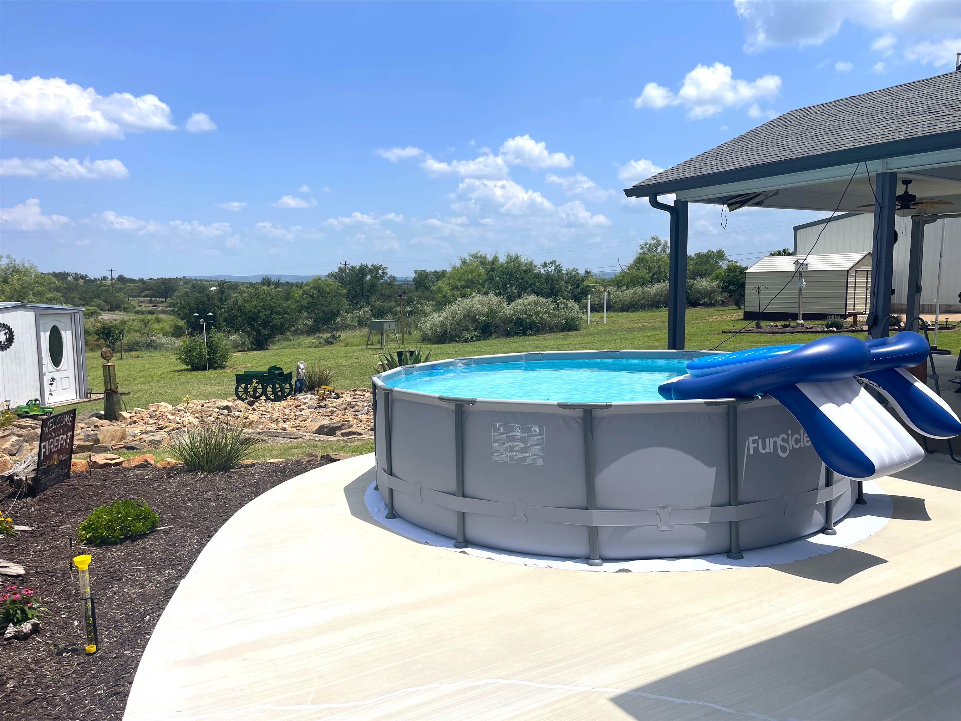 202 Rio Llano Drive West Llano, TX 78643 - Photo 18 of 29 a view of swimming pool with a yard and mountain view