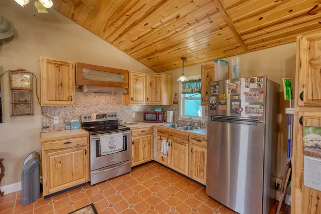 a view of a back yard of the house with a yard