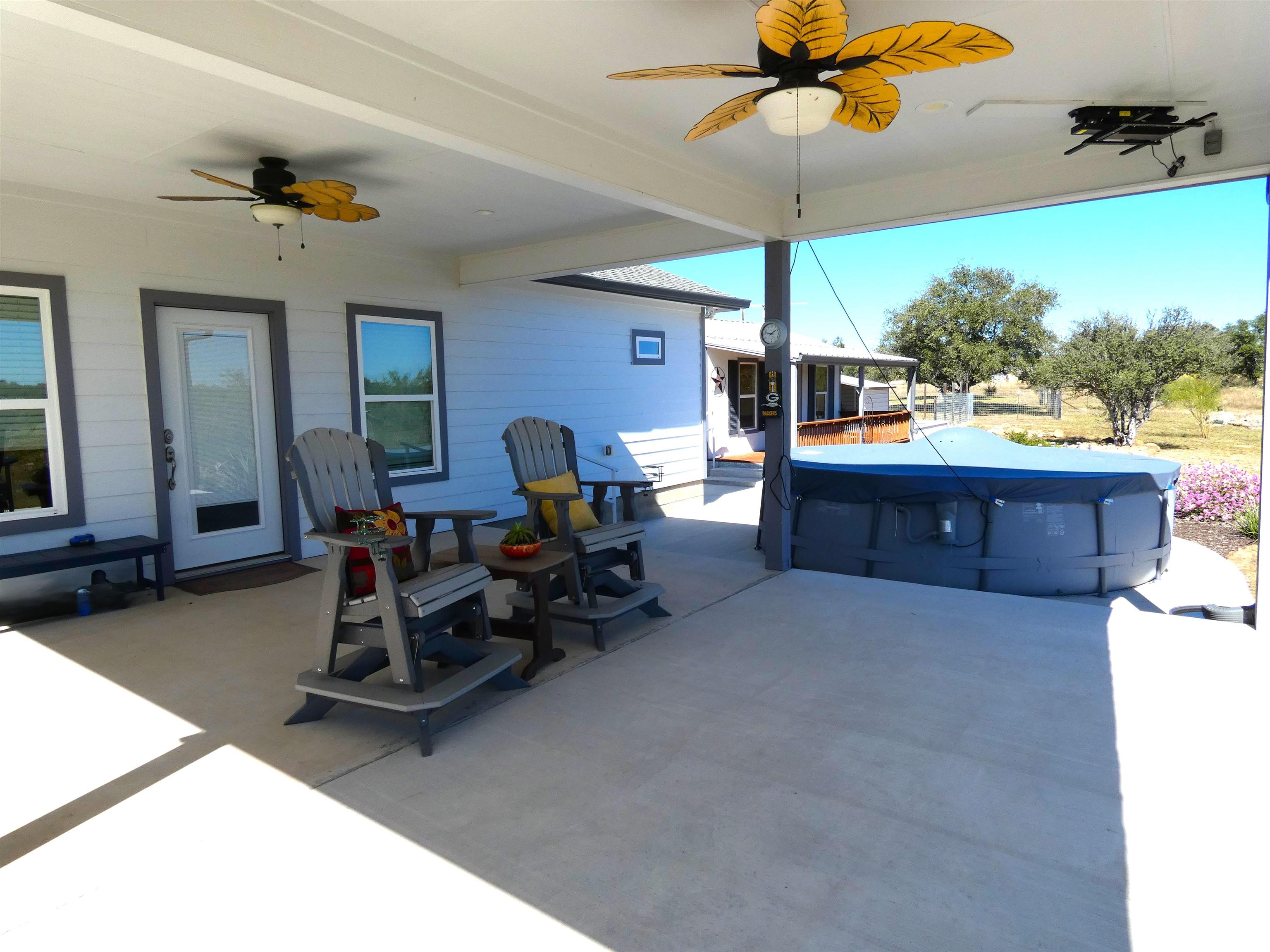 202 Rio Llano Drive West Llano, TX 78643 - Photo 5 of 29 a living room with furniture a chandelier and a floor to ceiling window