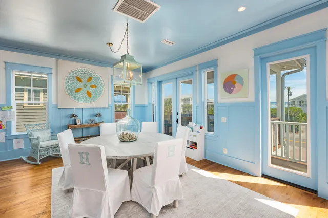 a view of a dining room with furniture wooden floor and chandelier