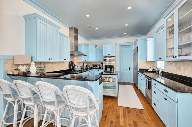 a kitchen with granite countertop a sink stove and cabinets
