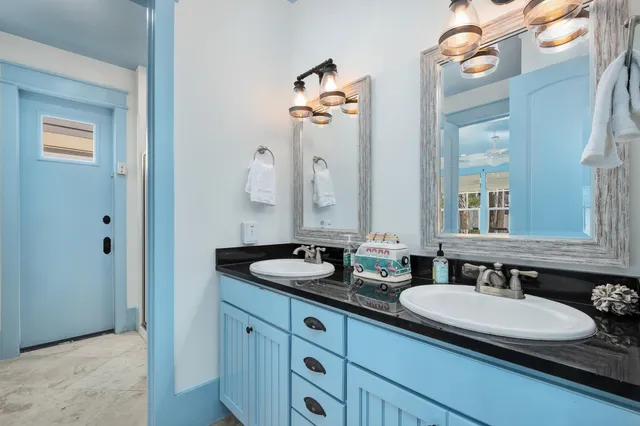 a bedroom with furniture and a large window