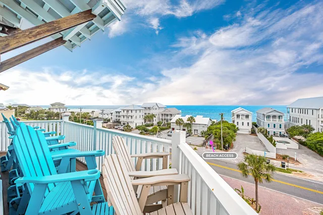 a view of a balcony with wooden chairs