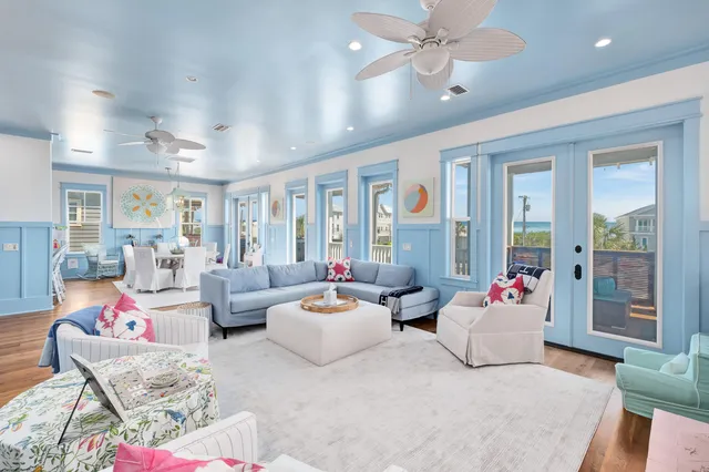 a living room with furniture kitchen and a table