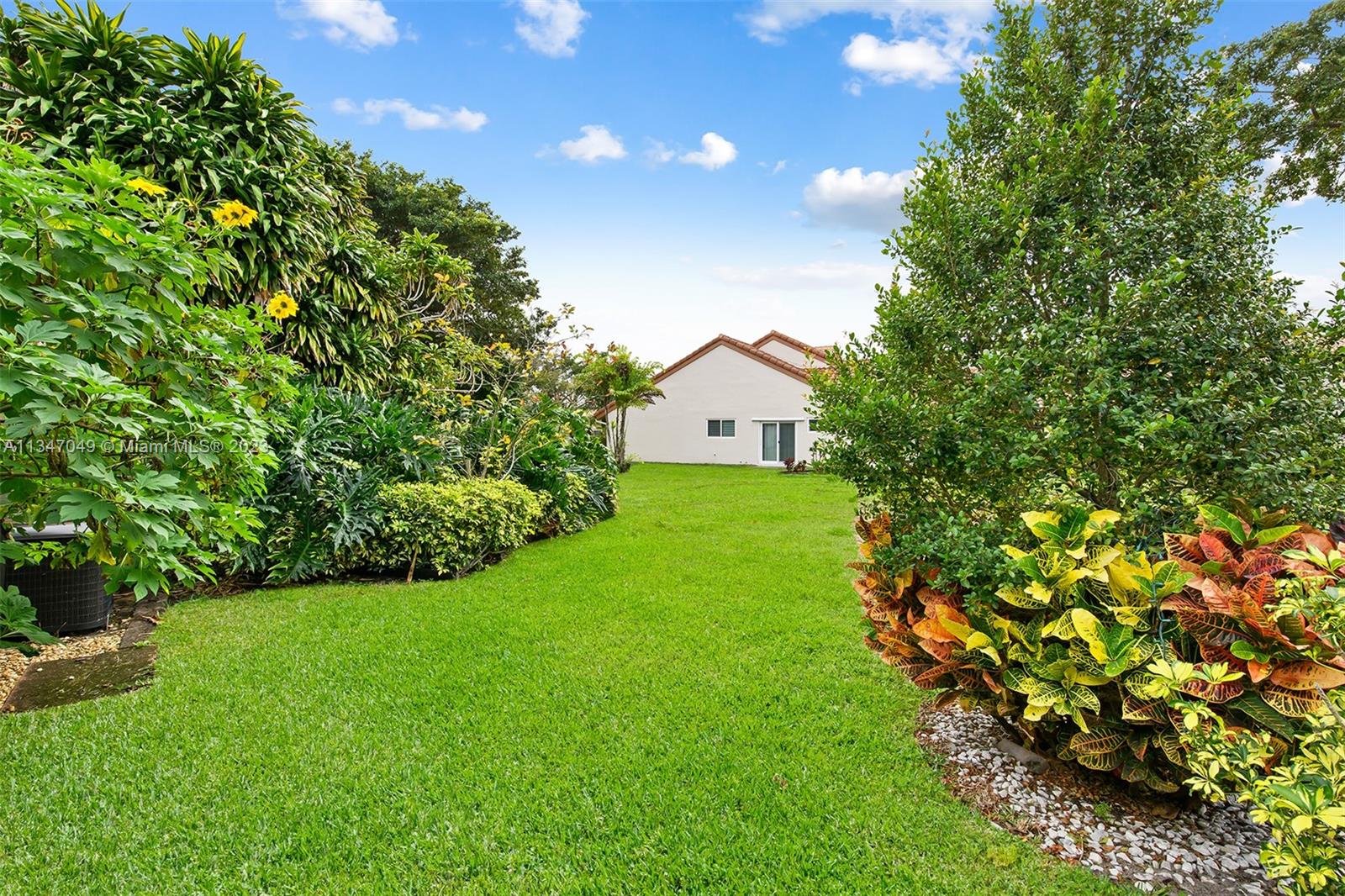 23281 Water Circle Boca Raton, FL 33486 - Photo 2 of 2 a view of a garden with plants and large trees