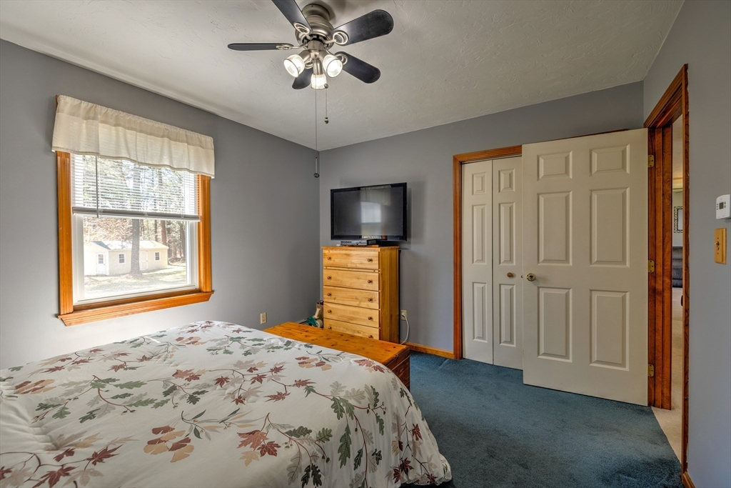 84 Long Hill Road Brookfield, MA 01506 - Photo 14 of 42 a bedroom with a bed and a flat screen tv