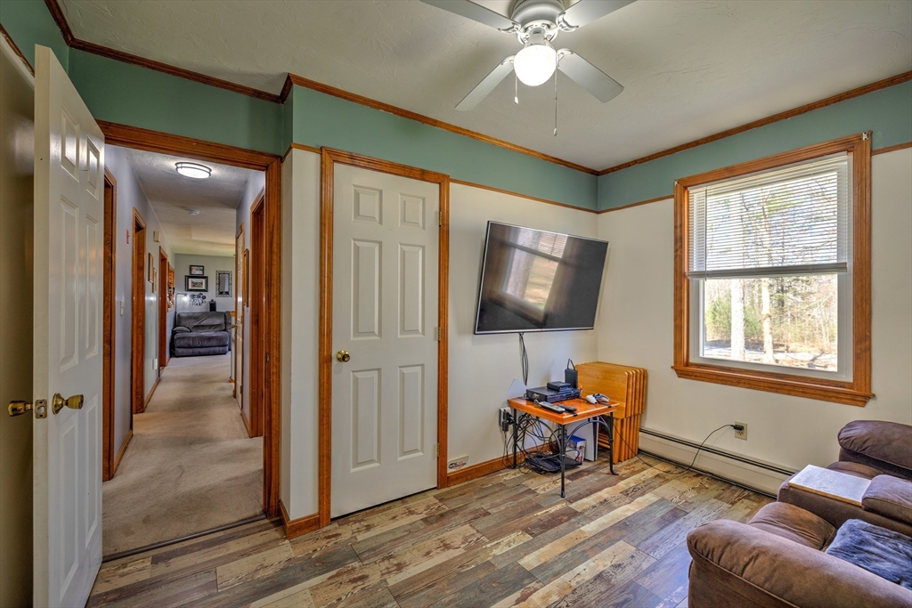 84 Long Hill Road Brookfield, MA 01506 - Photo 16 of 42 a living room with furniture and a flat screen tv