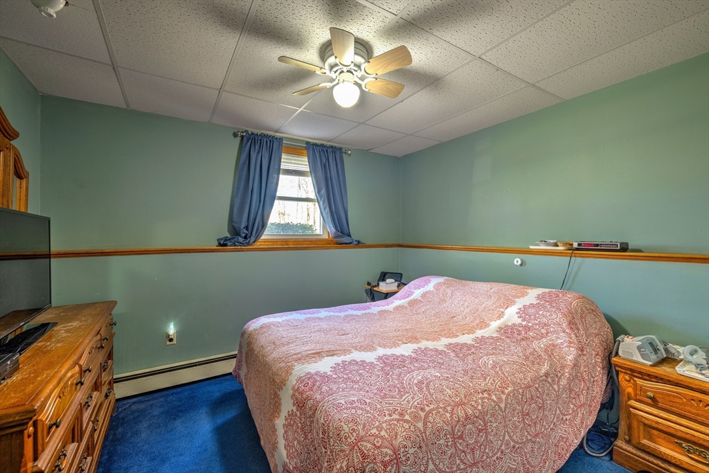 84 Long Hill Road Brookfield, MA 01506 - Photo 17 of 42 a bed sitting in a bedroom next to a window