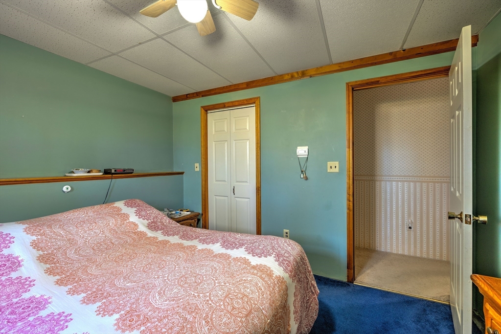84 Long Hill Road Brookfield, MA 01506 - Photo 18 of 42 a bedroom with a bed and wooden floor