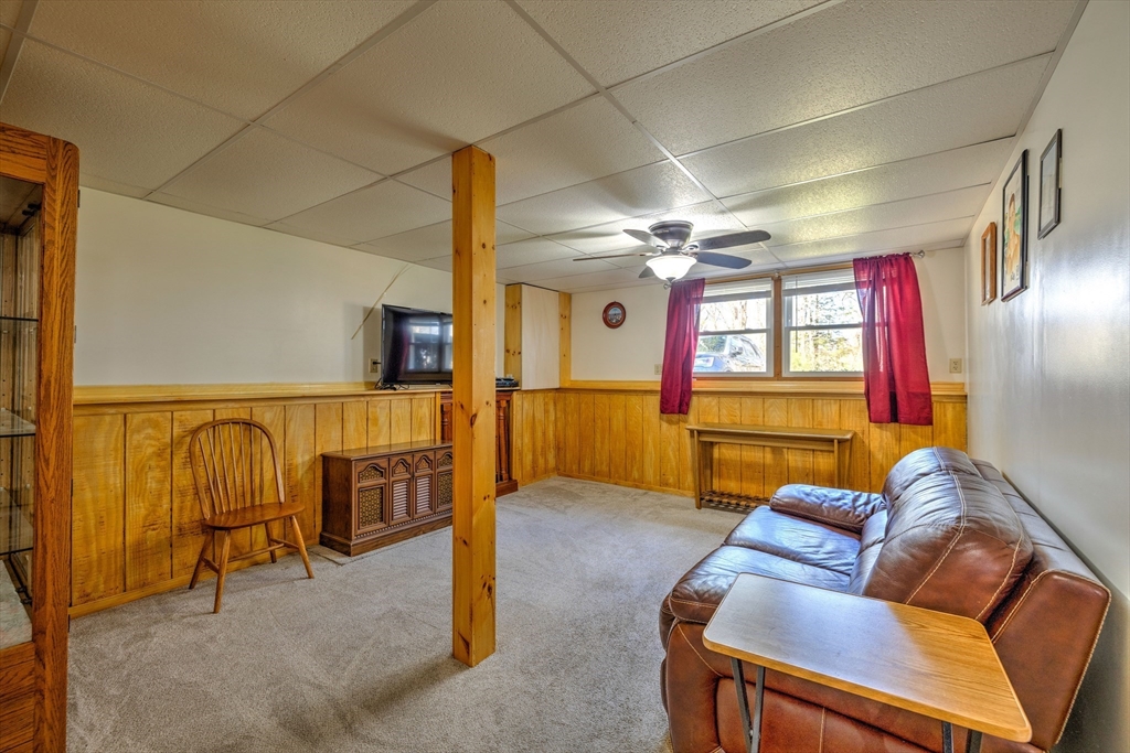 84 Long Hill Road Brookfield, MA 01506 - Photo 22 of 42 a living room with furniture a chandelier and a flat screen tv