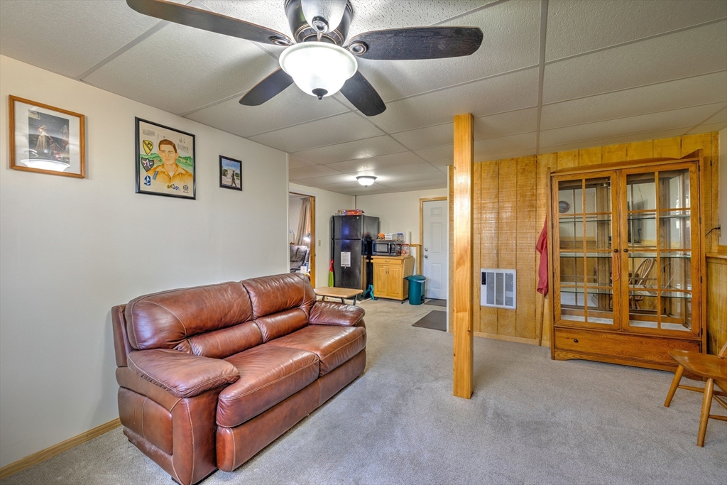 84 Long Hill Road Brookfield, MA 01506 - Photo 23 of 42 a living room with furniture and a chandelier