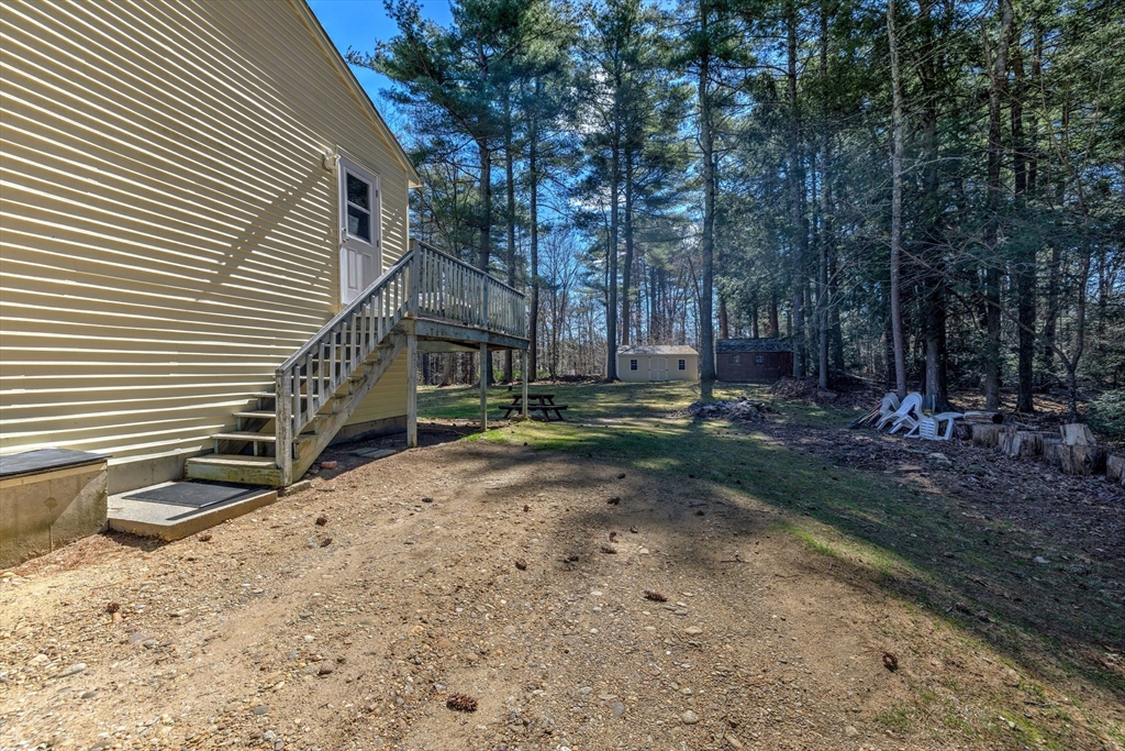 84 Long Hill Road Brookfield, MA 01506 - Photo 27 of 42 a backyard of a house with lots of green space