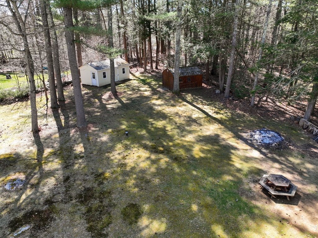 84 Long Hill Road Brookfield, MA 01506 - Photo 41 of 42 a backyard of a house with table and chairs