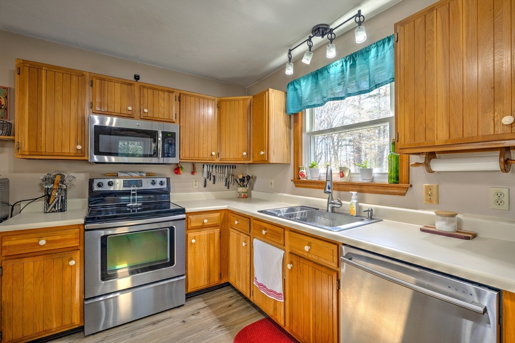 84 Long Hill Road Brookfield, MA 01506 - Photo 6 of 42 a kitchen with a sink stove and microwave