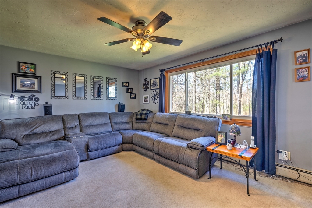 84 Long Hill Road Brookfield, MA 01506 - Photo 7 of 42 a living room with furniture and a large window