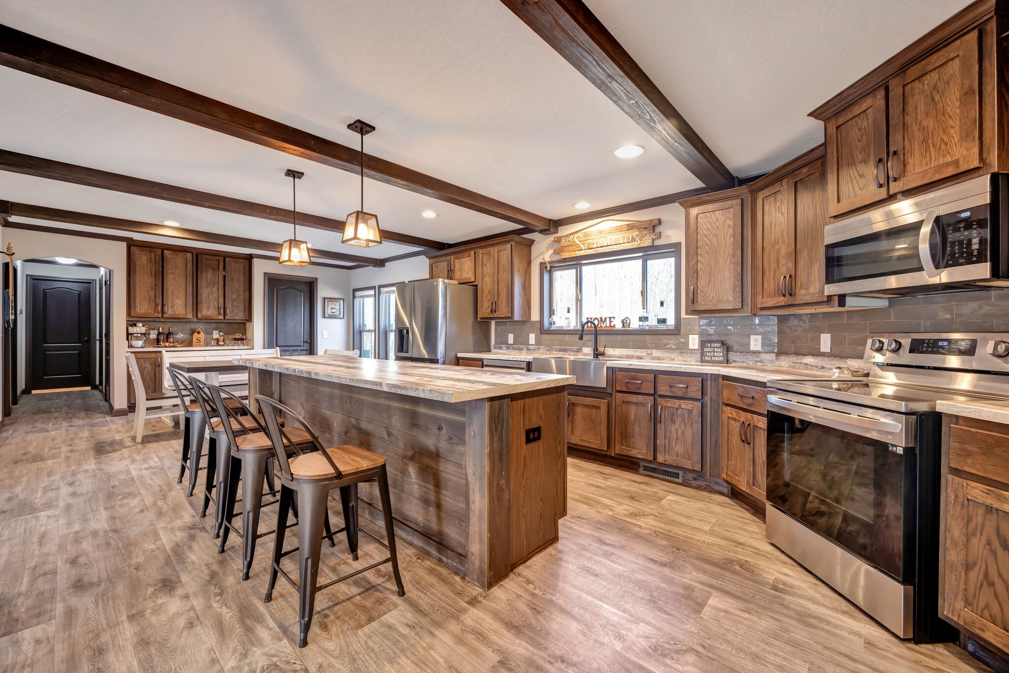 a kitchen with stainless steel appliances granite countertop table chairs sink and cabinets