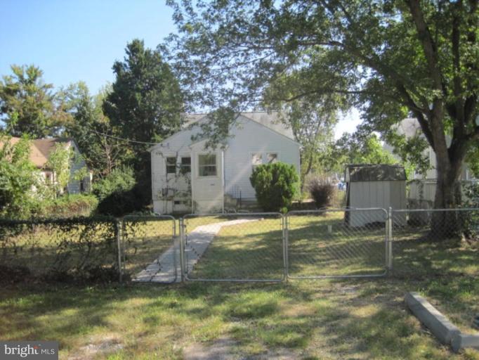 3813 Clarks Point Road Middle River, MD 21220 - Photo 1 of 6 a backyard of house with table and chairs and a large tree