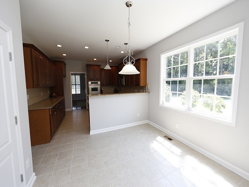 3324 Queensland Road Raleigh, NC 27614 - Photo 8 of 25 The light filled breakfast room is open to the kitchen and also the sunroom. Breakfast Room