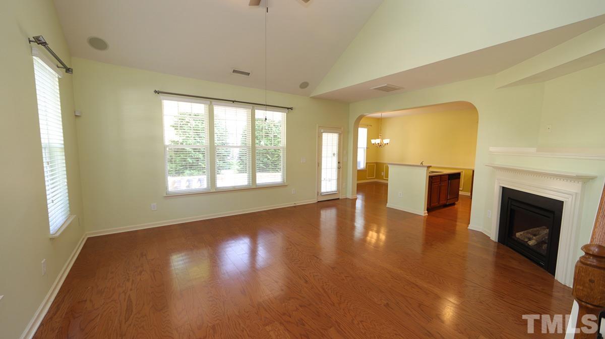 301 Dimock Way Wake Forest, NC 27587 - Photo 3 of 14 Family room with soaring ceiling is open to kitchen and dining.