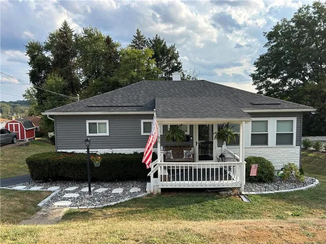 a view of a house with a yard and deck