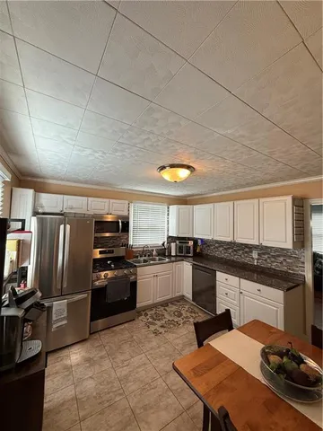 a kitchen with stainless steel appliances granite countertop a sink and cabinets