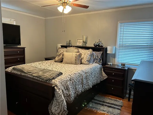 a bedroom with a bed and a chandelier