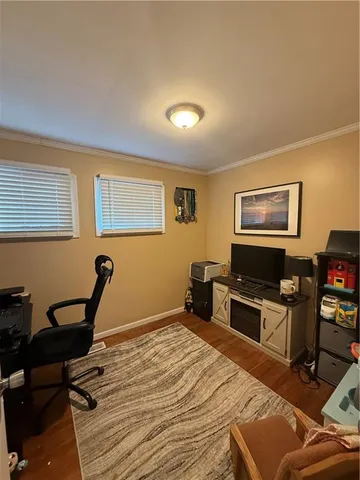 a bedroom with furniture and a flat screen tv