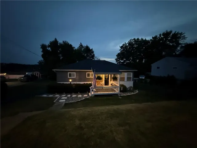 a front view of a house with a garden