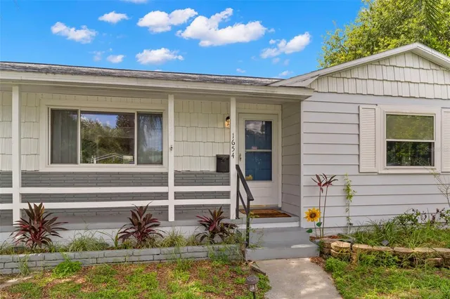 a view of house with backyard space and swimming pool