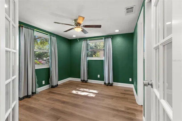 a view of a livingroom with a ceiling fan and window