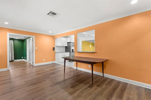 a room with wooden floor and furniture
