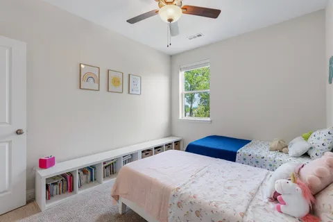 a bedroom with a bed and a book shelf