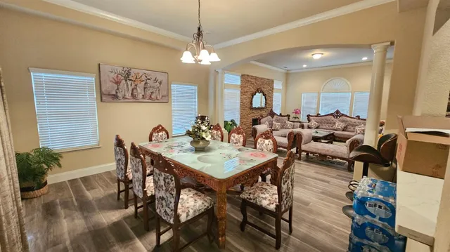 a view of a dining room with furniture and chandelier