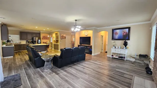a living room with furniture and kitchen view