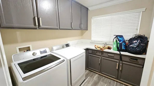 a view of a kitchen with sink and cabinets