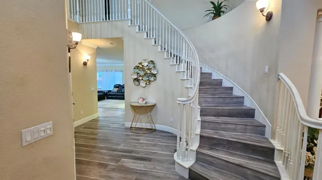 a view of entryway and hall with wooden floor