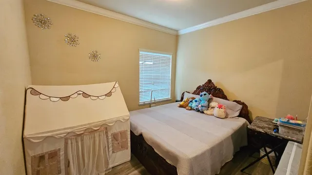 a bedroom with a bed and a dresser