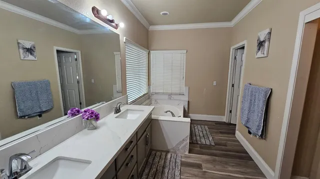 a bathroom with a sink vanity and mirror